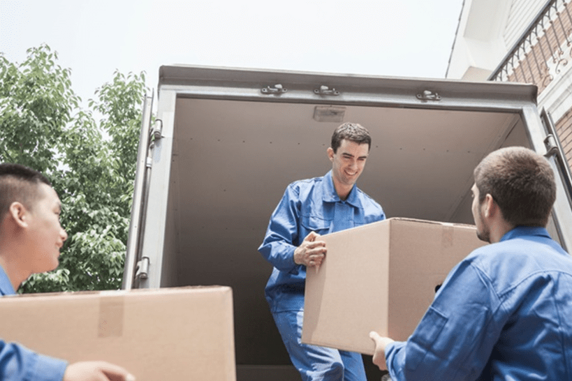 moving-team-unloading-boxes-from-truck-home-relocation.png